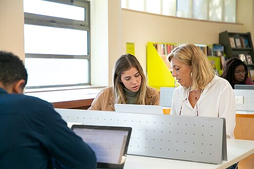 Lehrerin und Schülerin am Computer